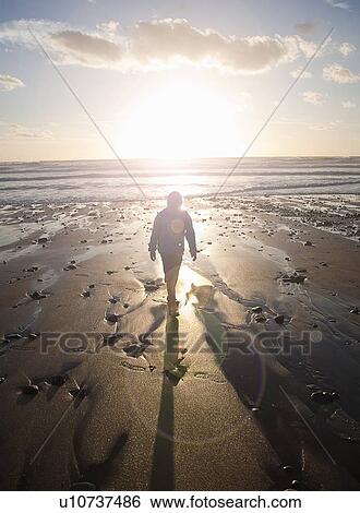 Boy walking on beach View Large Photo Image Stock Photograph - Boy walking on beach. Fotosearch