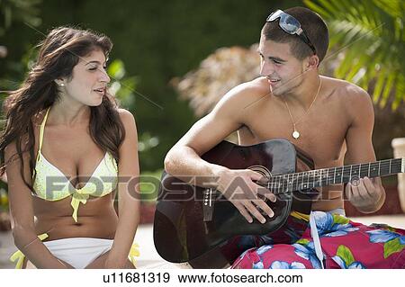 Brother and sister relaxing by pool View Large Photo Image Stock Photo - Brother and sister relaxing by pool. Fotosearch
