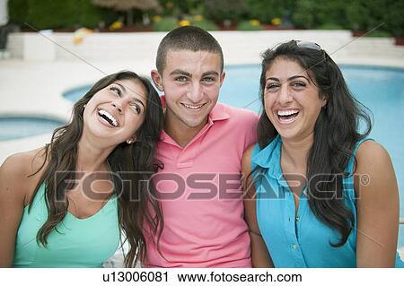 Stock Image - Brother and sisters smiling together. Fotosearch