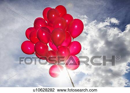 Bunch of red balloons in blue sky View Large Photo Image Stock Image - Bunch of red balloons in blue sky. Fotosearch