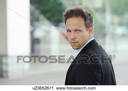 Businessman standing at window View Large Photo Image Stock Image - Businessman standing at window. Fotosearch