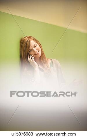 Businesswoman on cell phone in office View Large Photo Image Stock Image - Businesswoman on cell phone in office. Fotosearch