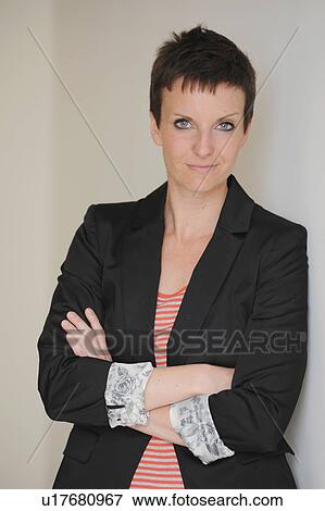 Businesswoman standing with arms crossed View Large Photo Image Stock Photo - Businesswoman standing with arms crossed. Fotosearch