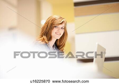 Businesswoman using computer at desk View Large Photo Image Stock Image - Businesswoman using computer at desk. Fotosearch
