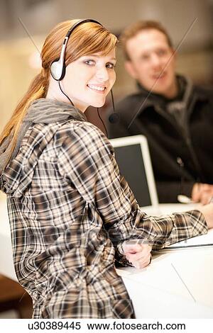 Businesswoman wearing headphones View Large Photo Image Stock Photography - Businesswoman wearing headphones. Fotosearch