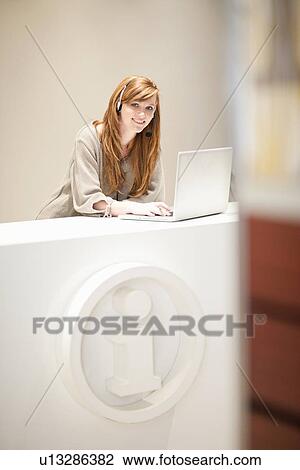 Businesswoman wearing headset in office View Large Photo Image Stock Image - Businesswoman wearing headset in office. Fotosearch