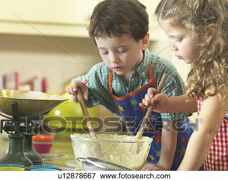Children baking together in kitchen View Large Photo Image Stock Photo - Children baking together in kitchen. Fotosearch