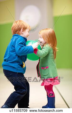 Stock Photo - Children playing with balloon. Fotosearch