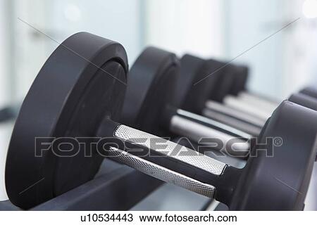 Close up of free weights in gym View Large Photo Image Stock Image - Close up of free weights in gym. Fotosearch