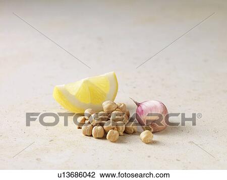 Stock Image - Close up of lemon, chickpeas and garlic. Fotosearch