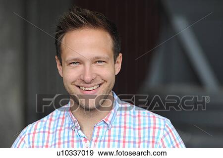 Stock Photo - Close up of man’s smiling face. Fotosearch