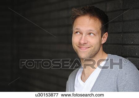 Stock Photo - Close up of smiling man’s face. Fotosearch