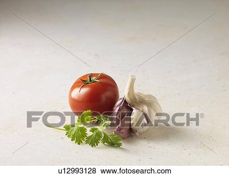 Stock Photo - Close up of tomato, garlic and parsley. Fotosearch