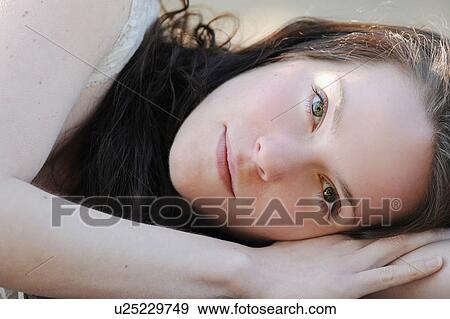 Close up of woman laying on ground View Large Photo Image Stock Photo - Close up of woman laying on ground. Fotosearch