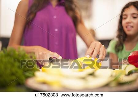 Close up of woman slicing vegetables View Large Photo Image Stock Photo - Close up of woman slicing vegetables. Fotosearch