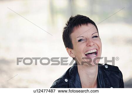 Stock Photo - Close up of woman’s laughing face. Fotosearch