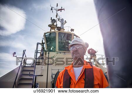 Close up of worker on tug boat View Large Photo Image Stock Image - Close up of worker on tug boat. Fotosearch