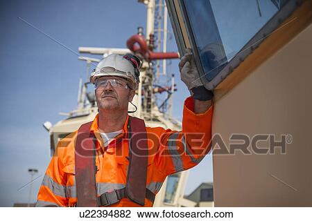 Close up of worker on tug boat View Large Photo Image Stock Image - Close up of worker on tug boat. Fotosearch