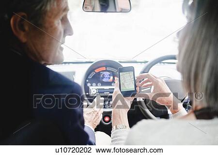 Couple getting directions on cell phone View Large Photo Image Stock Image - Couple getting directions on cell phone. Fotosearch
