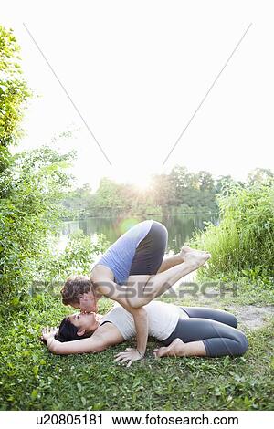 Couple kissing and practicing yoga View Large Photo Image Stock Image - Couple kissing and practicing yoga. Fotosearch