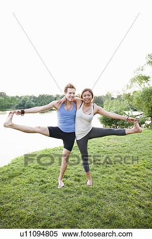 Couple practicing yoga by water View Large Photo Image Stock Photography - Couple practicing yoga by water. Fotosearch
