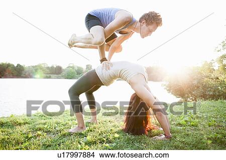 Couple practicing yoga in garden View Large Photo Image Picture - Couple practicing yoga in garden. Fotosearch
