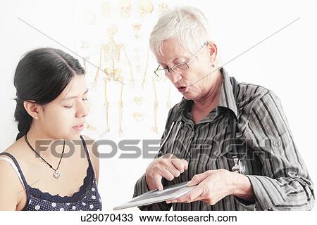 Doctor showing x-ray to teenage girl View Large Photo Image Stock Image - Doctor showing x-ray to teenage girl. Fotosearch