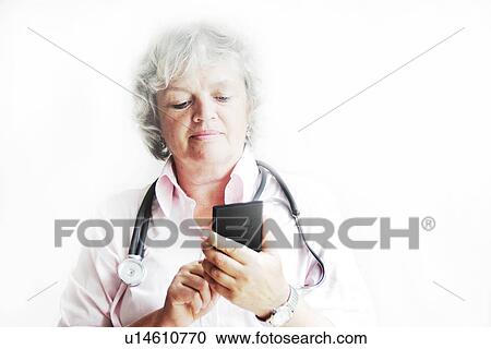 Stock Image - Doctor using calculator in office. Fotosearch