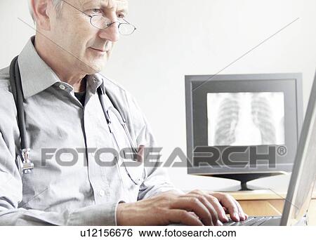Doctor using laptop in office View Large Photo Image Stock Photograph - Doctor using laptop in office. Fotosearch