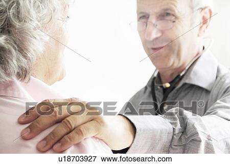 Doctor with hand on patient’s shoulder View Large Photo Image Stock Photo - Doctor with hand on patient’s shoulder. Fotosearch
