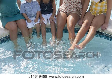 Family dangling feet in swimming pool View Large Photo Image Stock Photography - Family dangling feet in swimming pool. Fotosearch