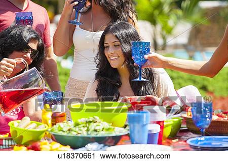 Family eating together outdoors View Large Photo Image Stock Image - Family eating together outdoors. Fotosearch
