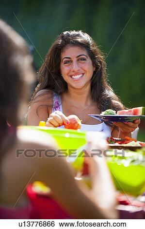 Family eating together outdoors View Large Photo Image Stock Photograph - Family eating together outdoors. Fotosearch