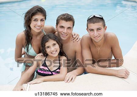 Family relaxing in swimming pool View Large Photo Image Stock Photography - Family relaxing in swimming pool. Fotosearch