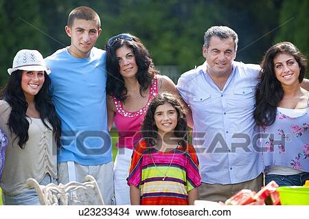Family standing together outdoors View Large Photo Image Picture - Family standing together outdoors. Fotosearch