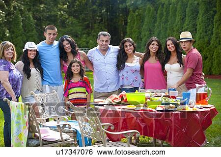 Family standing together outdoors View Large Photo Image Stock Photograph - Family standing together outdoors. Fotosearch