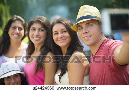 Stock Photograph - Family taking picture of themselves. Fotosearch