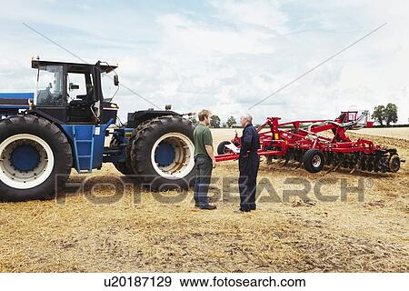 Farmers talking in crop field View Large Photo Image Stock Photo - Farmers talking in crop field. Fotosearch