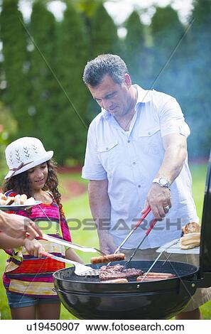 Father and daughter grilling outdoors View Large Photo Image Stock Photo - Father and daughter grilling outdoors. Fotosearch
