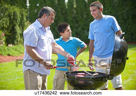 Father and sons grilling outdoors View Large Photo Image Stock Image - Father and sons grilling outdoors. Fotosearch
