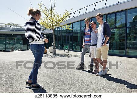 Friends walking together in courtyard View Large Photo Image Stock Photography - Friends walking together in courtyard. Fotosearch