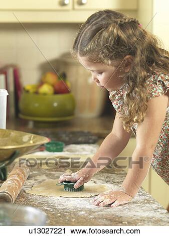 Girl cutting out cookies in kitchen View Large Photo Image Stock Image - Girl cutting out cookies in kitchen. Fotosearch