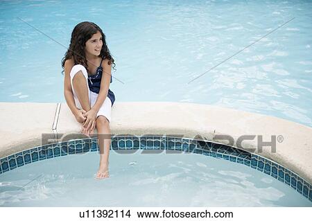Girl dangling foot in swimming pool View Large Photo Image Picture - Girl dangling foot in swimming pool. Fotosearch