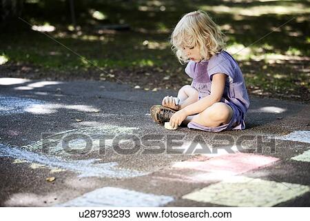 Girl drawing with sidewalk chalk View Large Photo Image Stock Image - Girl drawing with sidewalk chalk. Fotosearch