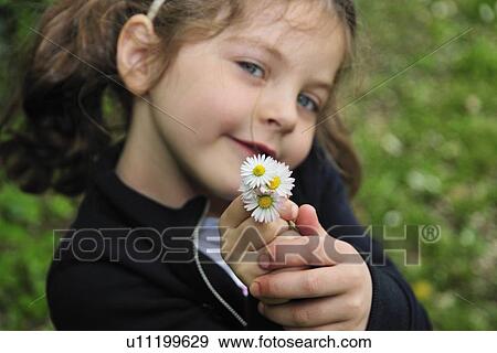 Girl holding bunch of daisies View Large Photo Image Stock Photo - Girl holding bunch of daisies. Fotosearch