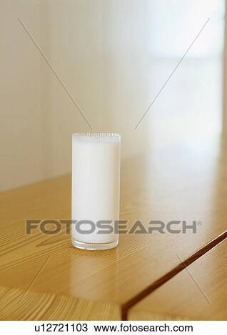 Glass of milk on table View Large Photo Image Stock Image - Glass of milk on table. Fotosearch