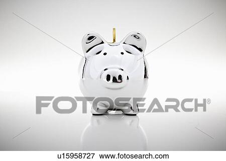 Gold coin dropping into piggy bank View Large Photo Image Stock Photo - Gold coin dropping into piggy bank. Fotosearch