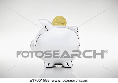 Gold coin dropping into piggy bank View Large Photo Image Stock Photo - Gold coin dropping into piggy bank. Fotosearch