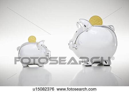 Gold coins dropping into piggy banks View Large Photo Image Stock Photograph - Gold coins dropping into piggy banks. Fotosearch