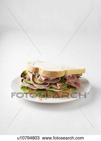 Stock Image - Ham and cucumber sandwich on plate. Fotosearch